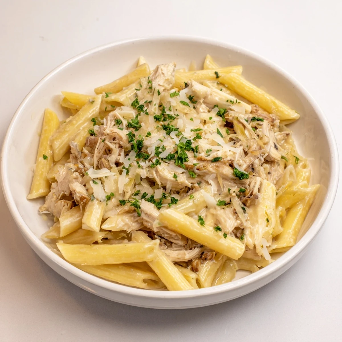 A bowl of Tinis Creamy Chicken Pasta, rich and creamy, perfect for a satisfying dinner.