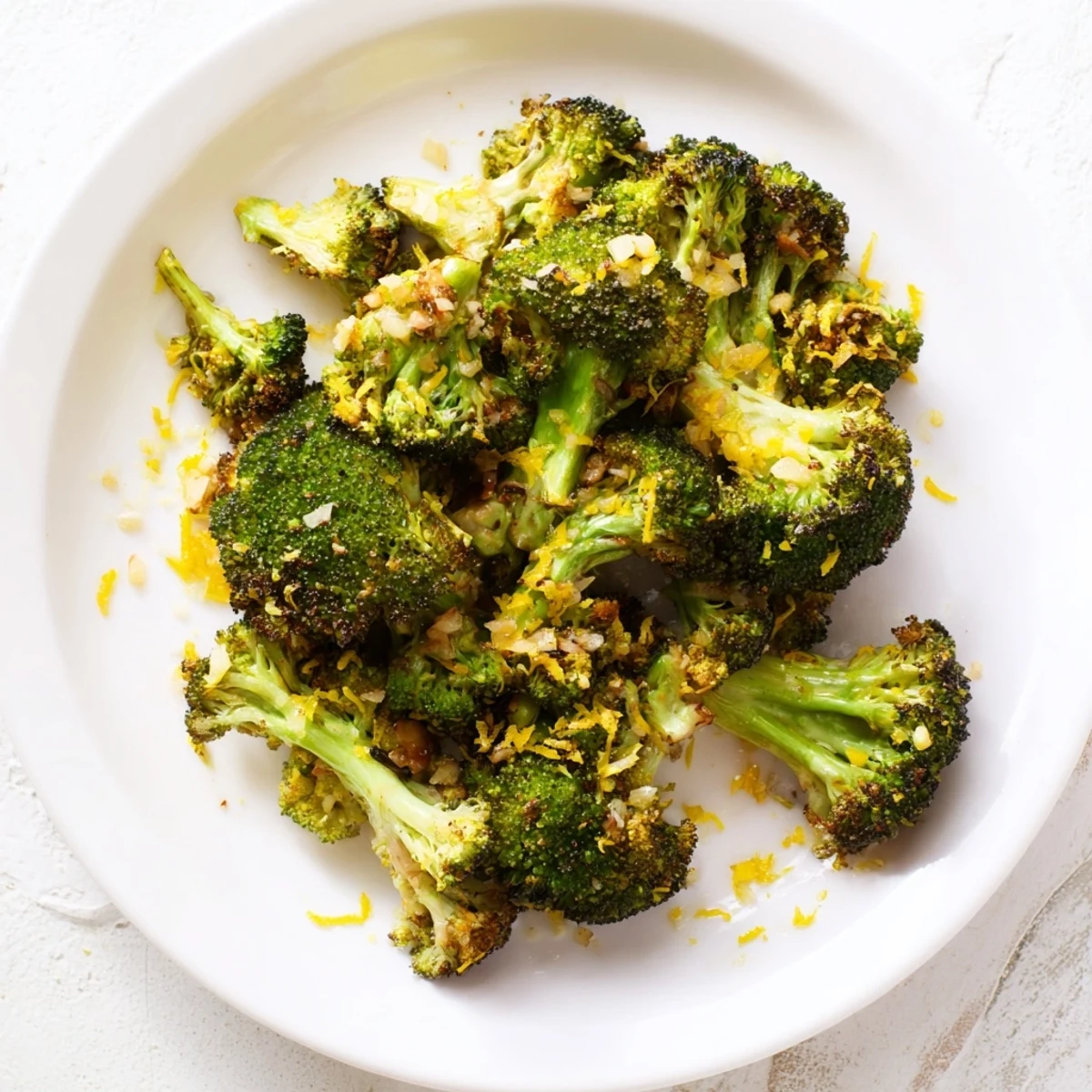 Golden-brown Lemon Garlic Roasted Broccoli glistens after roasting, ready to serve with a squeeze of fresh lemon.