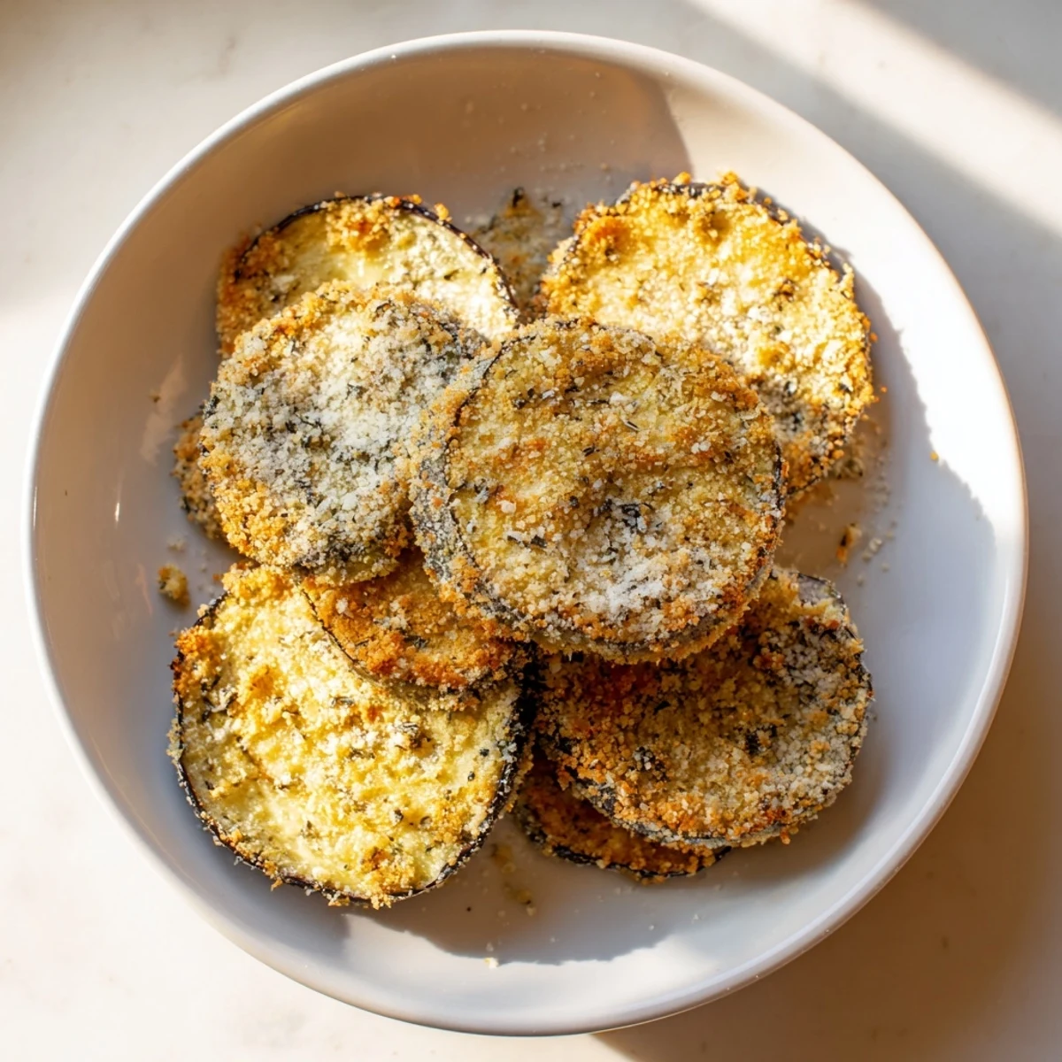 Golden and irresistibly crispy, these Eggplant Parmesan Chips are the perfect, easy vegetarian snack.