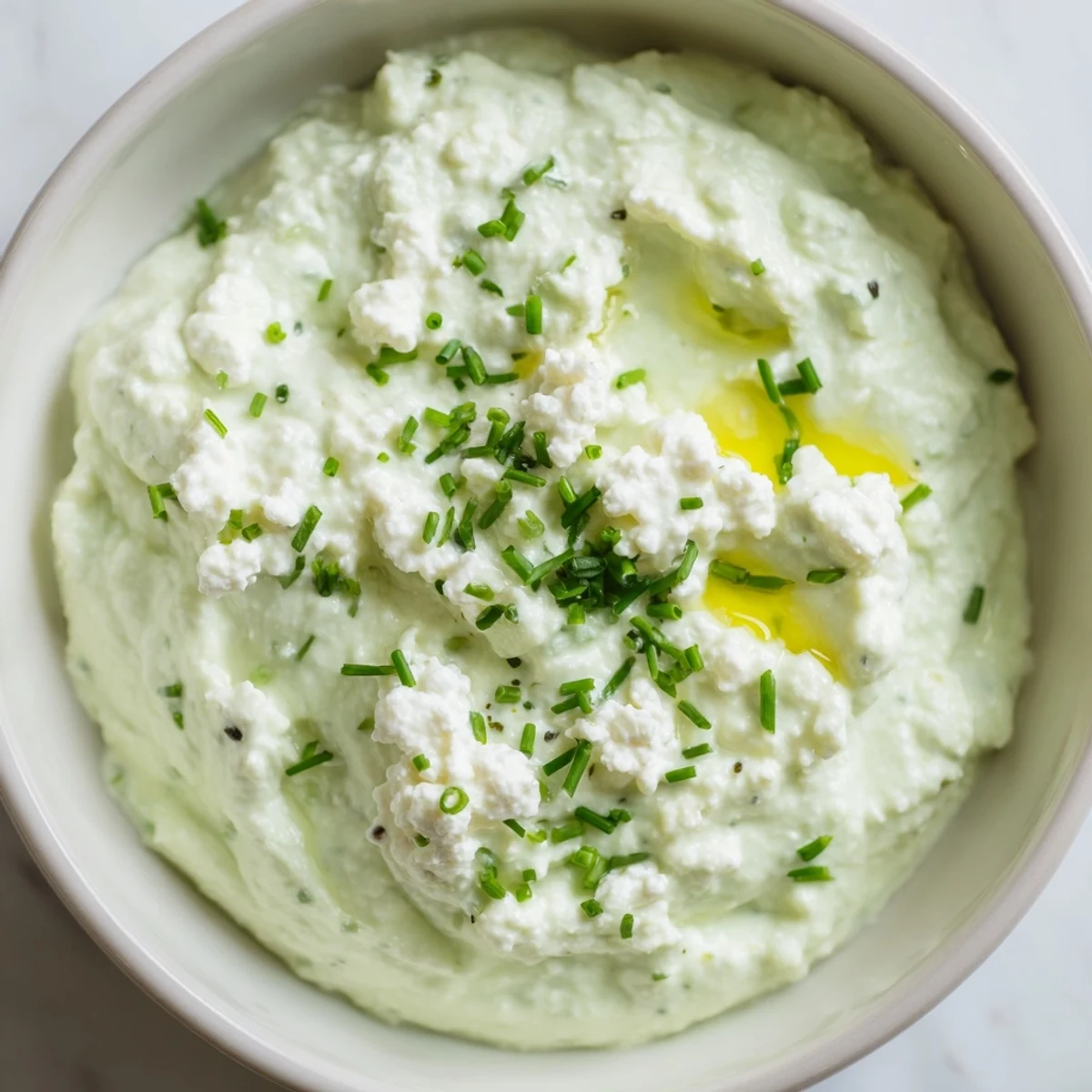 This easy avocado cottage cheese dip, blended smooth, is perfect for a quick and healthy snack.