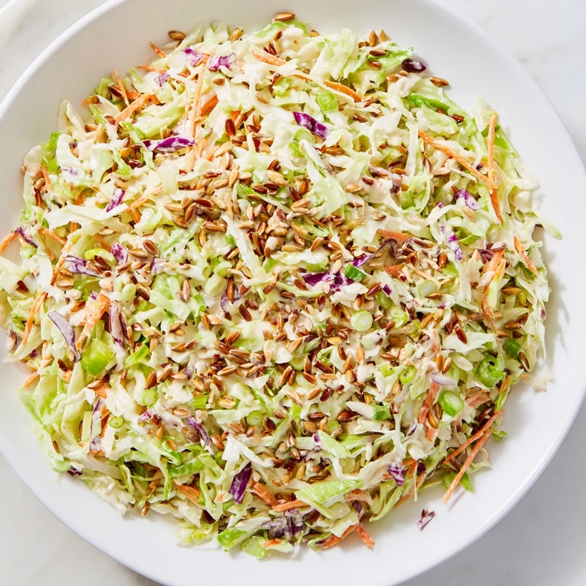Fresh, colorful crunchy coleslaw salad with sunflower seeds, perfect for a summer BBQ.