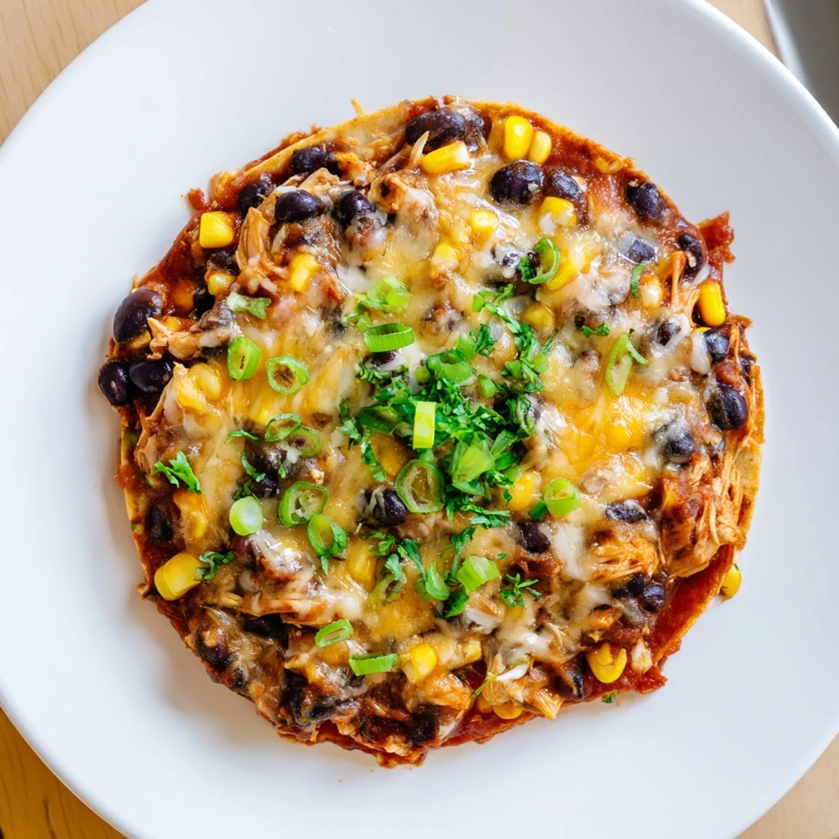 Warm, cheesy Chicken Enchilada Skillet with visible tortilla strips and fresh cilantro for garnish.