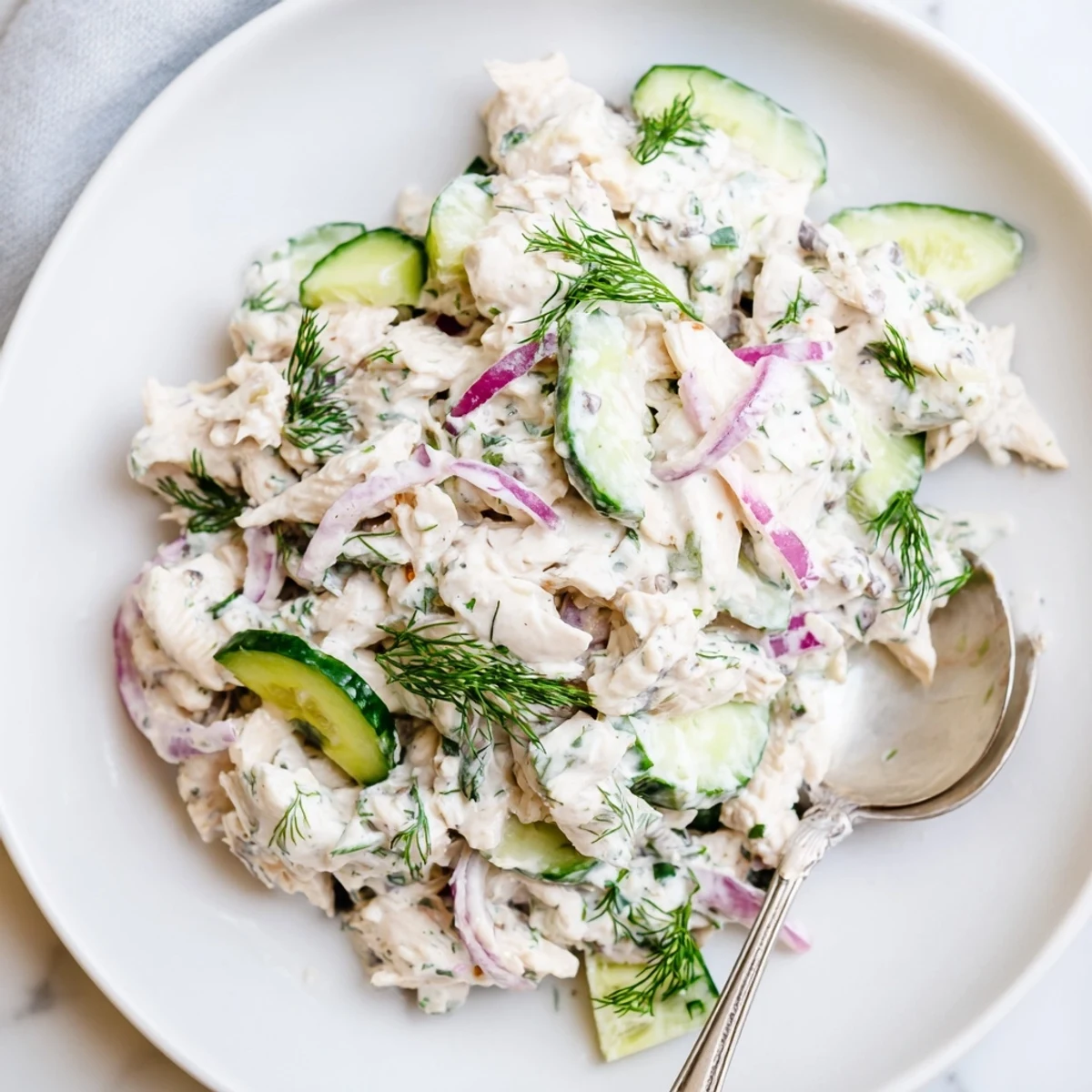 A vibrant bowl of Creamy Cucumber Chicken Salad with tender chicken, crisp cucumber slices, and fresh dill garnish.
