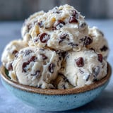 A bowl of chilled Greek Yogurt Cookie Dough reveals brown sugar sweetness and glossy chocolate chips.