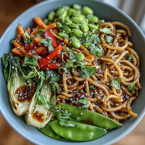A close-up of Shirataki Noodle Bowl garnished with toasted sesame seeds and fresh cilantro leaves.