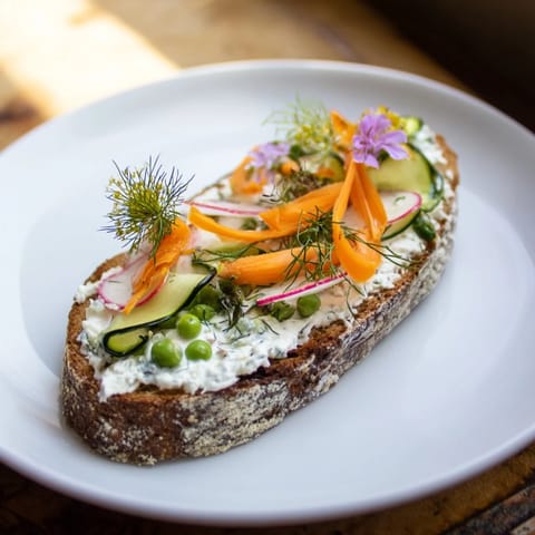 Toasted bread piled high with vegetables makes for delicious Fresh Meadow-Inspired Garden Vegetable Tartines.