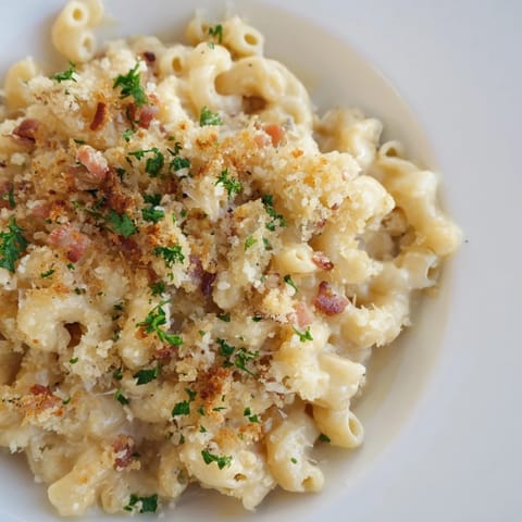 Creamy, cheesy Tinis Mac and Cheese features perfectly cooked macaroni, rich sauce, and crunchy bacon bits.