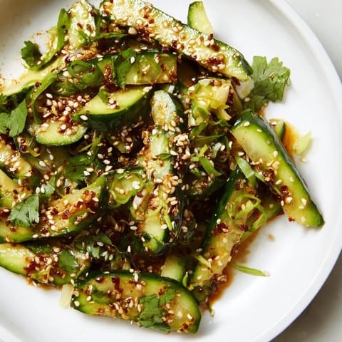 This Zesty Shake Cucumber Salad features glistening cucumber slices and a sprinkle of sesame seeds.