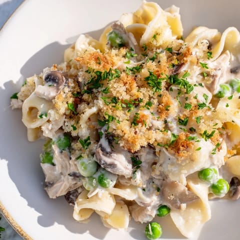 Creamy, comforting Tuna Noodle Casserole loaded with vegetables and topped with breadcrumbs.