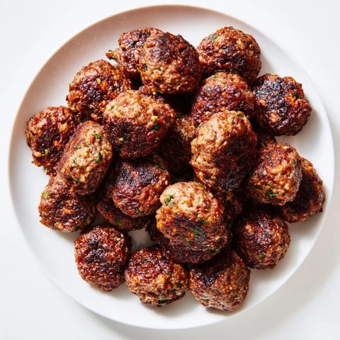Beautifully plated Turkish Köfte Meatballs with fresh parsley, ready alongside fluffy rice and warm flatbread.