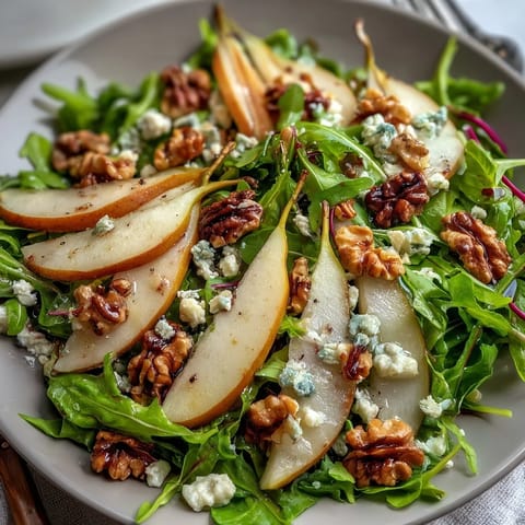 Fresh peppery arugula and sliced ripe pears topped with creamy crumbled blue cheese and toasted walnuts in the Arugula and Pear Bowl.