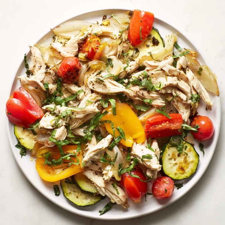 Golden-brown Basil-Soft Chicken and Veggie dinner on a sheet pan, ready to serve with fragrant herbs.