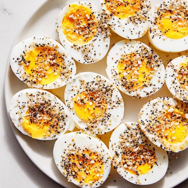 A colorful brunch board with hard-boiled eggs, generously topped with everything bagel seasoning, ready to serve.