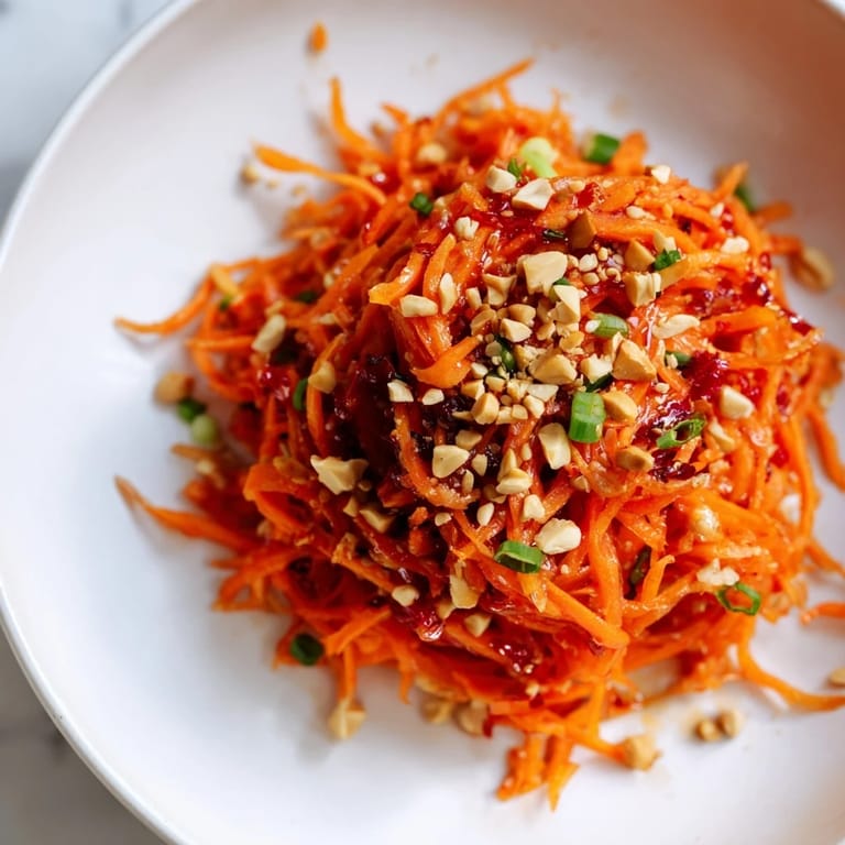 Close-up of a refreshing Spicy Carrot Salad, showcasing bright orange carrots and sesame seeds.