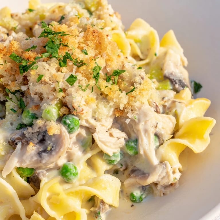 A close-up shot of a steaming hot baked Tuna Noodle Casserole, a delightful family meal.