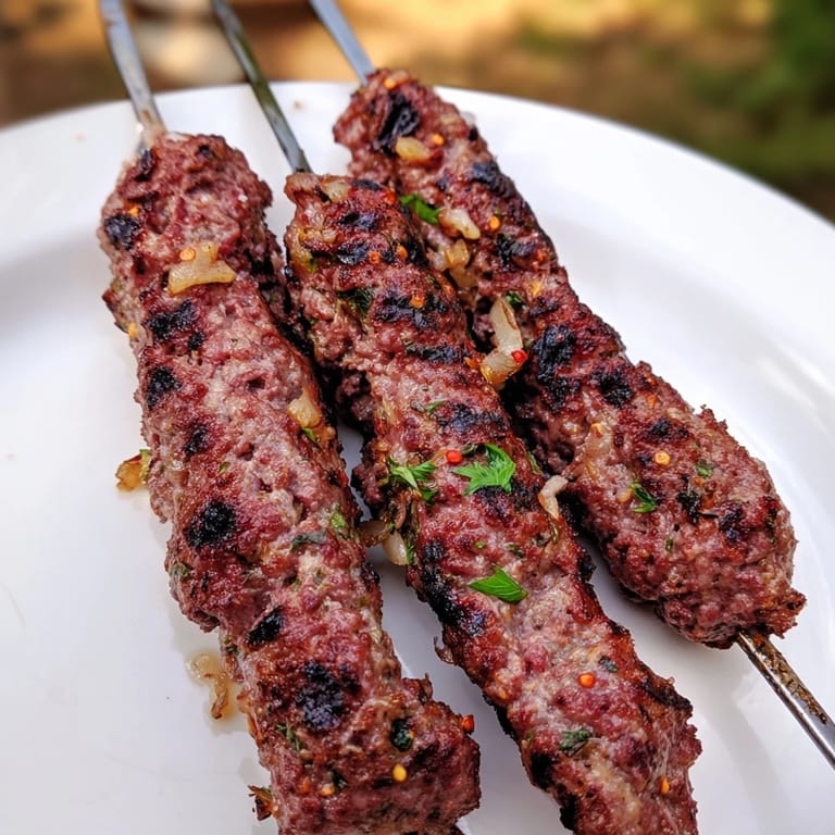Enjoy savory Iraqi Kebab Tikka; spiced meat kebabs on skewers grilled until perfectly browned.
