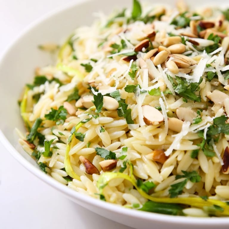 Fresh lemon zest brightens the Asparagus Lemon Orzo Salad, with shaved green asparagus, grated Parmesan, and toasted pine nuts in a light vinaigrette.