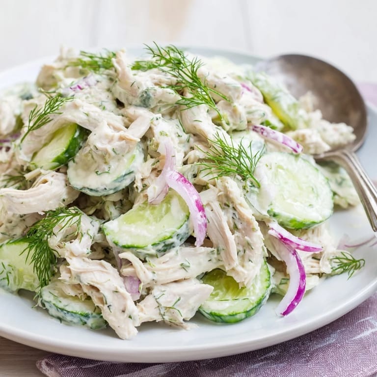 Chilled Creamy Cucumber Chicken Salad served on lettuce cups with red onion and a sprinkle of green onions.