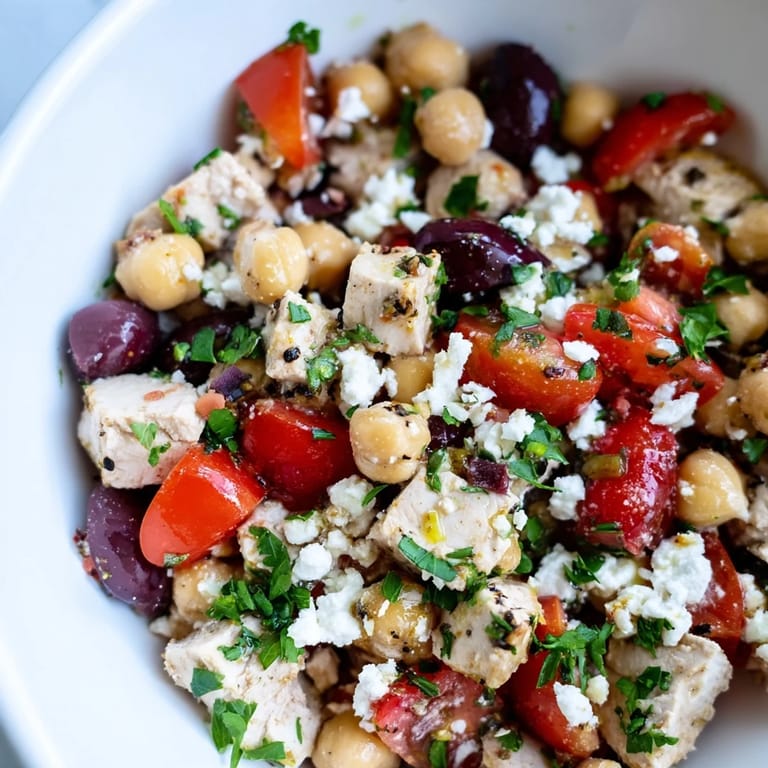Close-up of Mediterranean Chickpea Chicken Salad with juicy chicken, crisp cucumber, and briny olives, ready to serve.