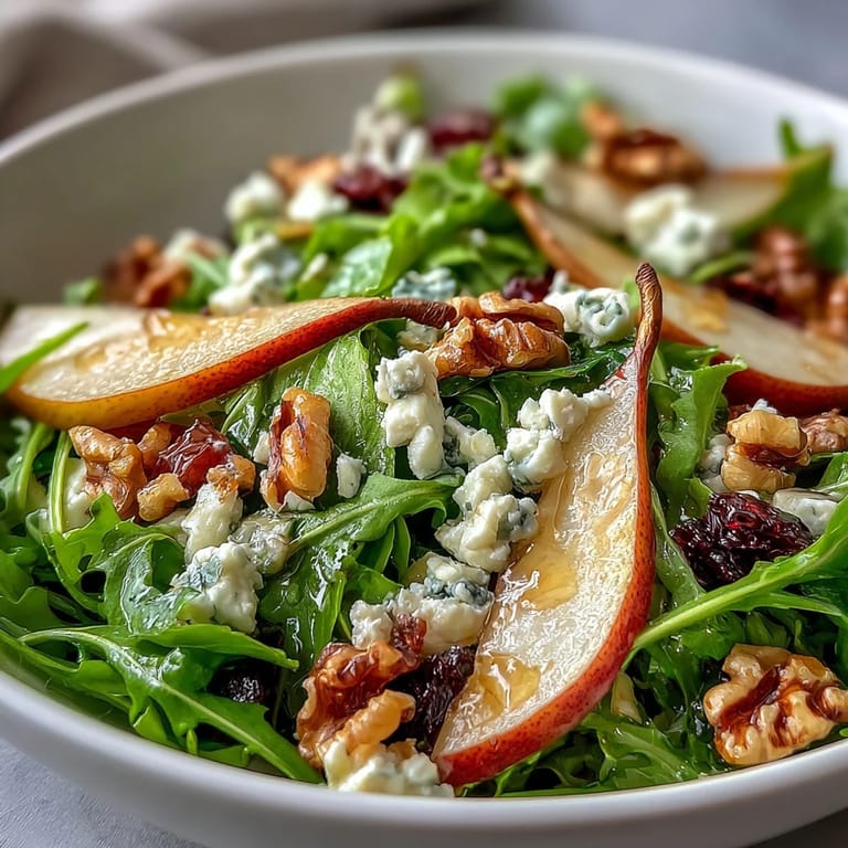 Drizzled with honey balsamic dressing, this Arugula and Pear Bowl is served ready to enjoy as a vibrant light salad.