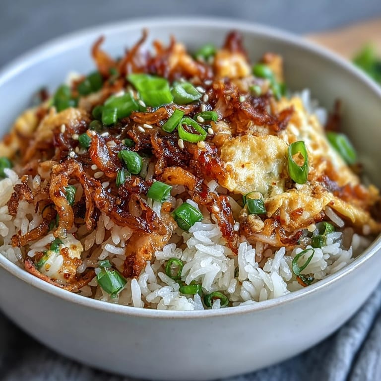 Golden fried rice topped with chili crisp and sesame seeds for a bold flavor kick.